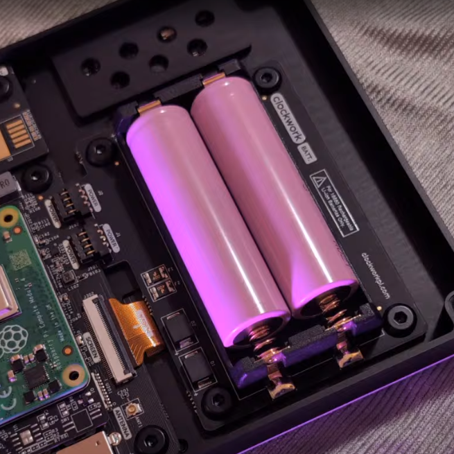 Two pink Samsung 18650 cells placed in the uConsole battery compartment above the Raspberry Pi board