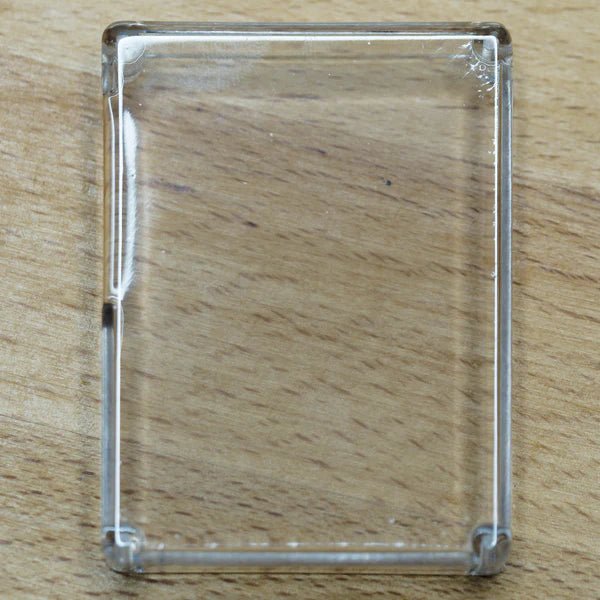 Transparent HackHeld Vega II case on a wooden surface