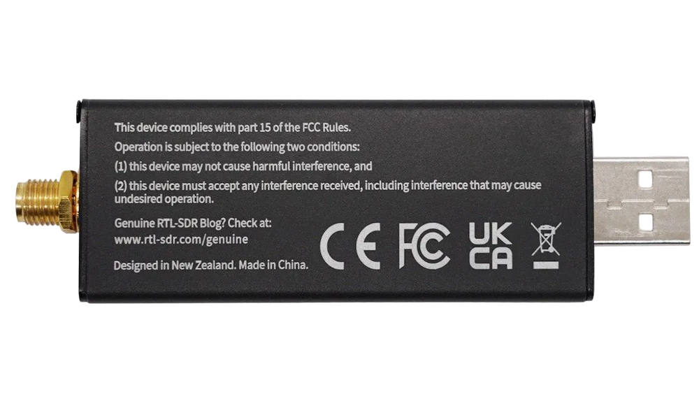 Back of the black RTL-SDR Blog V3 SDR receiver with FCC compliance text and certifications