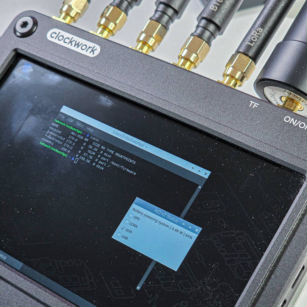AIO V2 on clockwork with antennas and a terminal showing the status of the GPS, LoRa and SDR modules