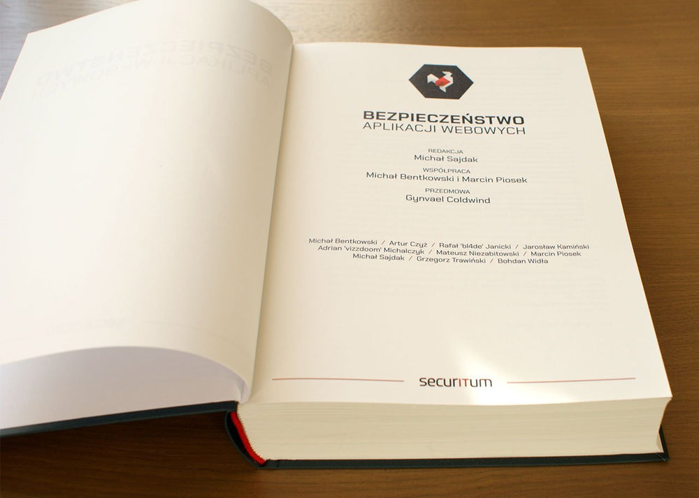 Aufgeschlagenes Buch Bezpieczeństwo aplikacji webowych auf der Titelseite mit Herausgeber Michał Sajdak und einer Autorenliste (Securitum)
