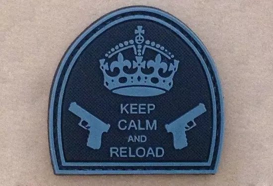 Naszywka - łukowata czarna naszywka z koroną, dwoma pistoletami i napisem Keep Calm And Reload, na jasnobrązowym tle