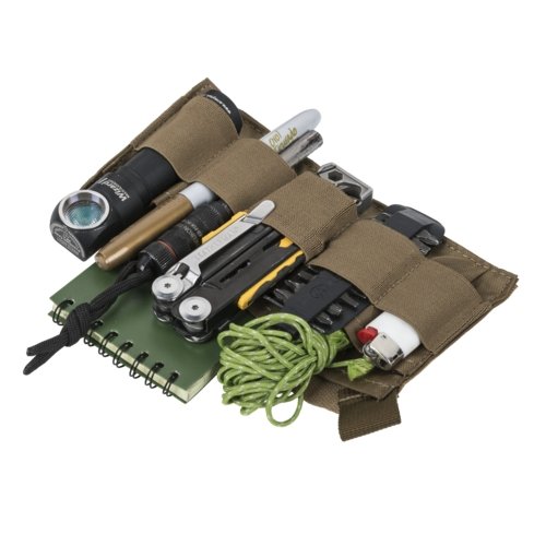 The organizer panel of the Helikon-Tex Bandicoot (coyote) laid flat - elastic loops holding a flashlight, a multitool, a pen, a lighter, paracord, a notebook and batteries, on white