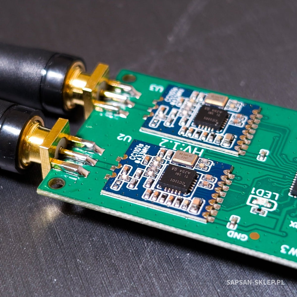 Close-up of the Evil Crow RF V2 board with two antennas attached and the CC1101 chips marked HV.1.2 visible
