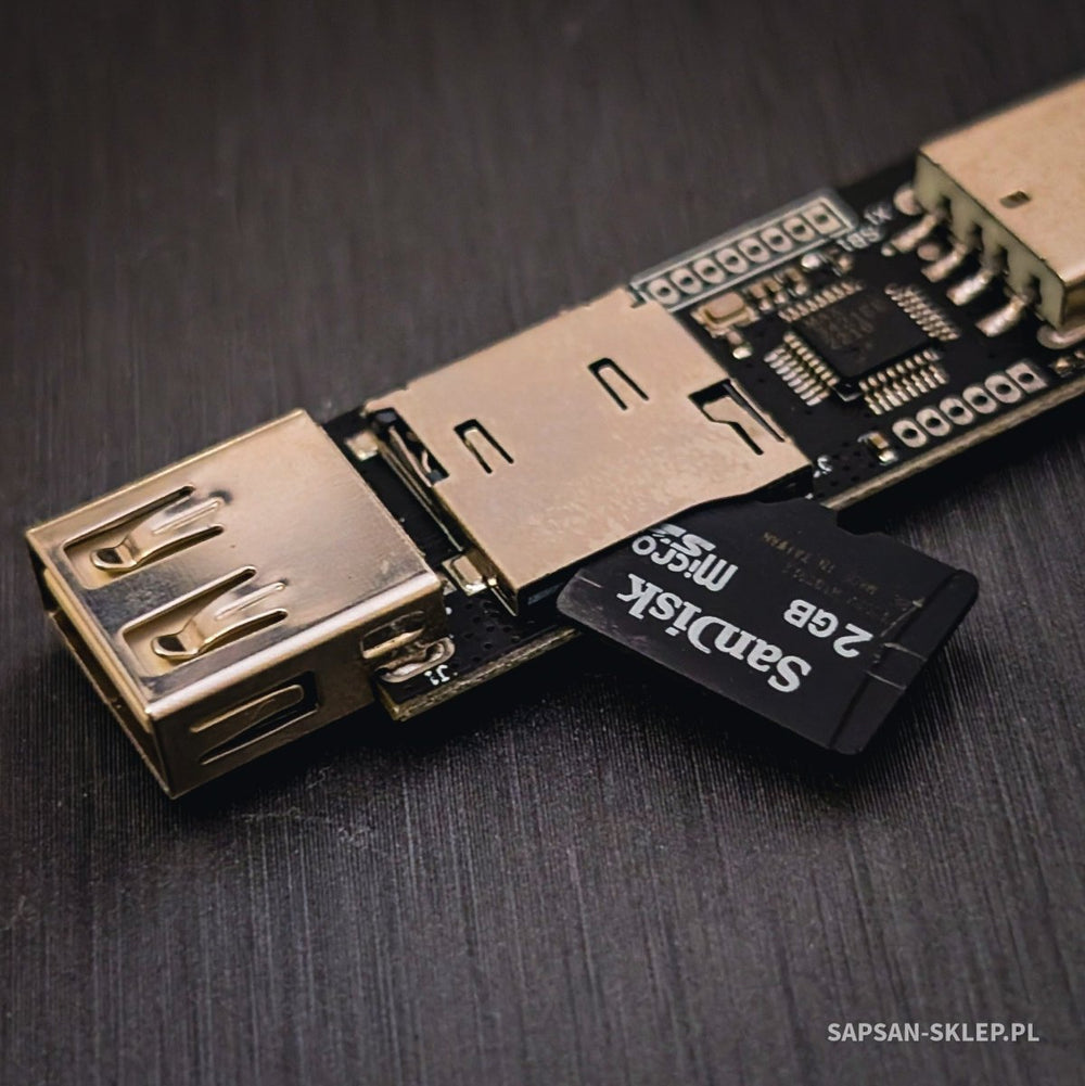 Close-up of the EvilCrow Hardware Keylogger WiFi with a USB-A socket and a SanDisk 2 GB microSD card inserted in the slot