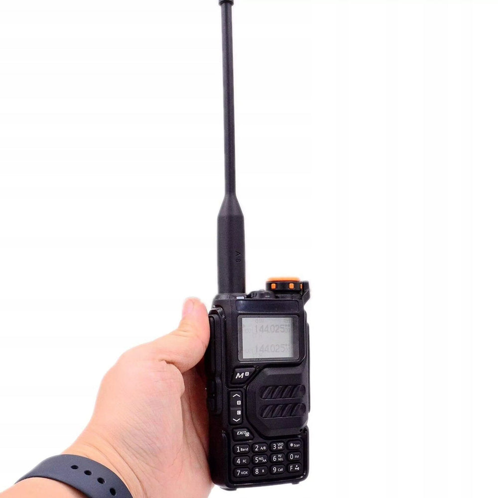 Quansheng UV-K5 radio held in a hand, showing its size