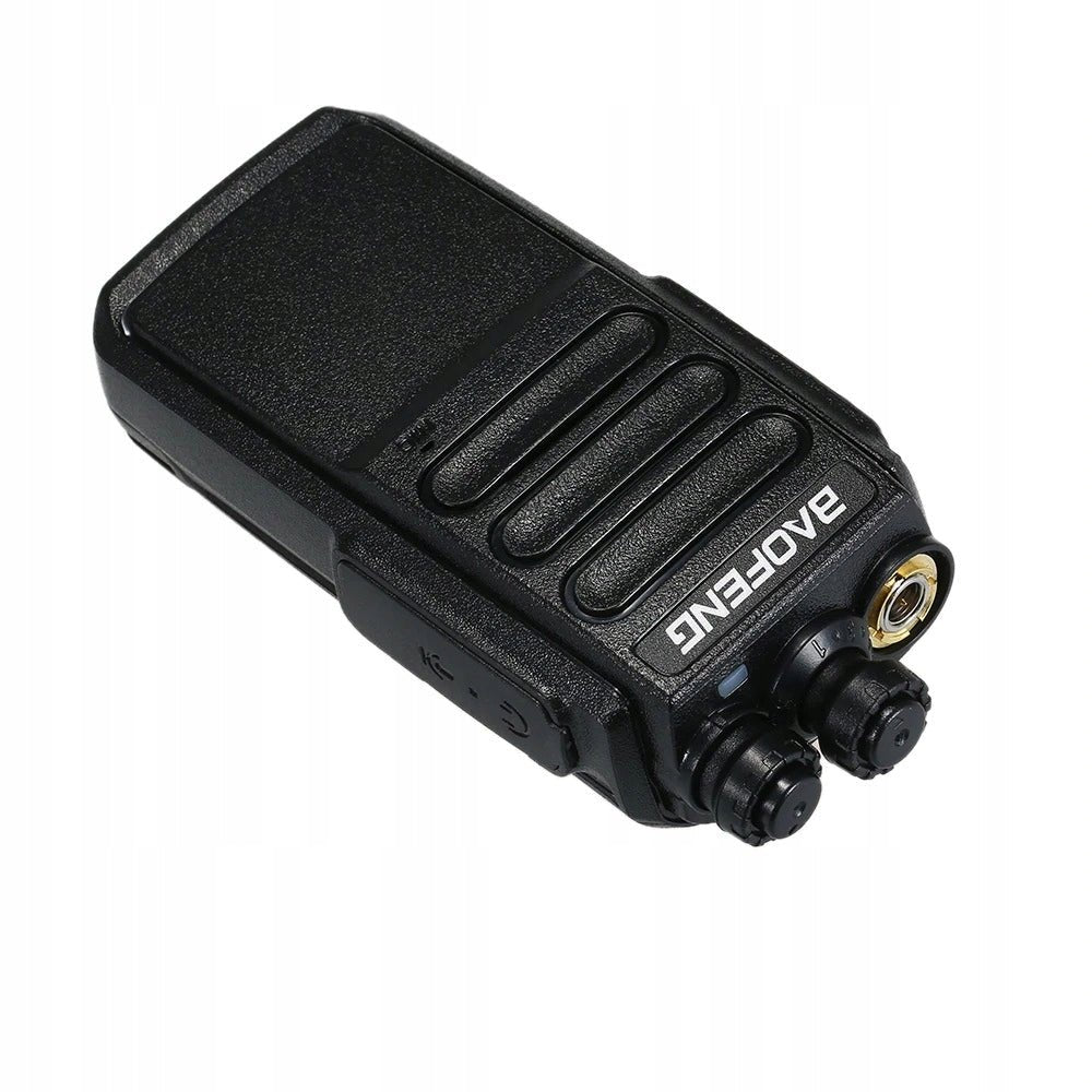 Baofeng C3 walkie-talkie lying down, showing the gold SMA antenna connector, the knobs and the accessory port on top