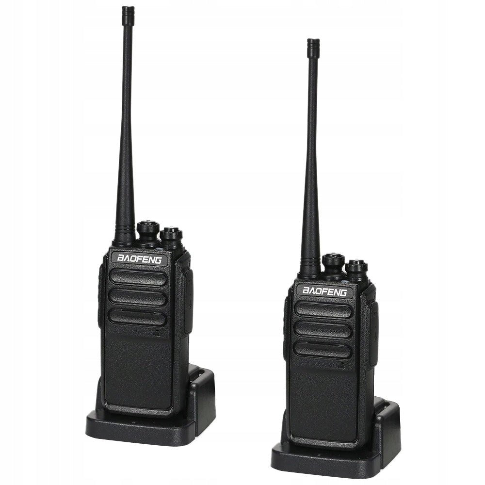 Two black Baofeng C3 walkie-talkies standing in desktop chargers, with antennas and knobs