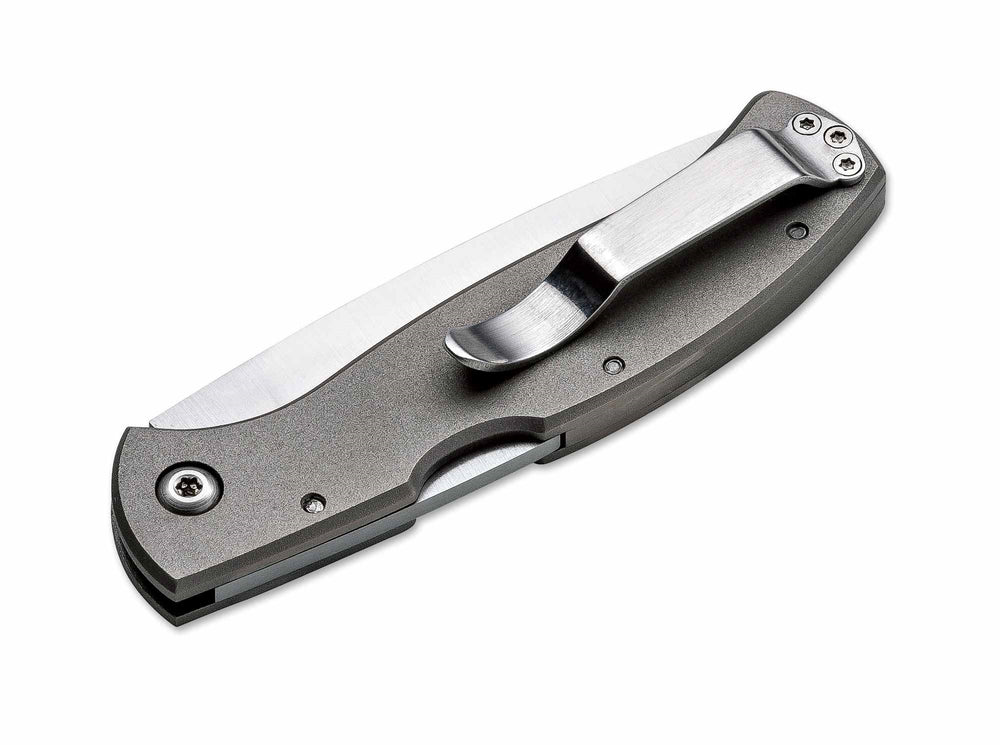 Folded Böker Plus Titan Drop knife with a grey titanium handle and a steel pocket clip