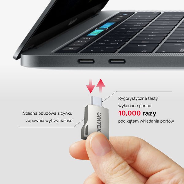 Dłoń trzyma adapter Unitek przy portach USB-C laptopa, z opisem wytrzymałej obudowy z cynku i testu ponad 10 000 wpięć