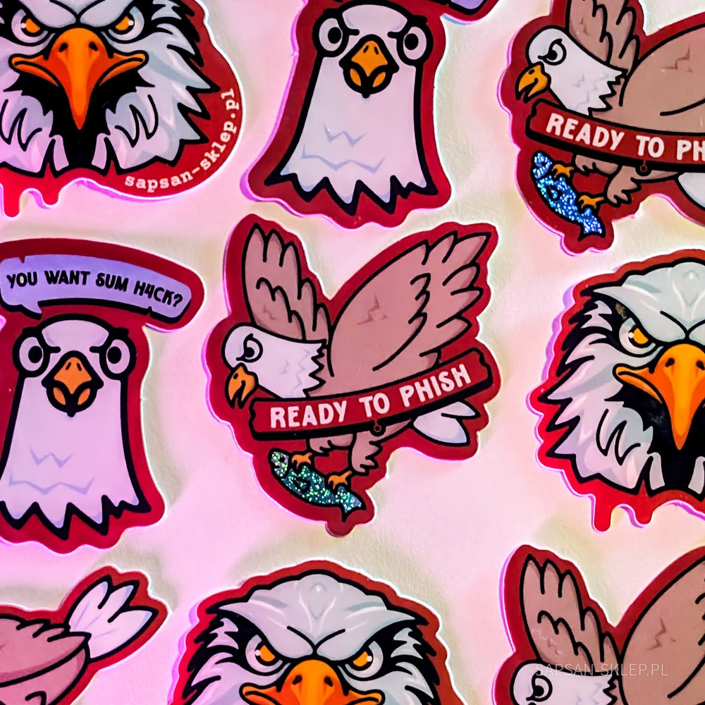 Close-up of SAPSAN stickers in pink lighting - die-cut stickers with the eagle mascots, including a flying eagle with the READY TO PHISH text carrying a glittery fish, an eagle with a YOU WANT SUM H4CK speech bubble and an angry eagle head with the sapsan-sklep.pl text, the SAPSAN-SKLEP.PL watermark