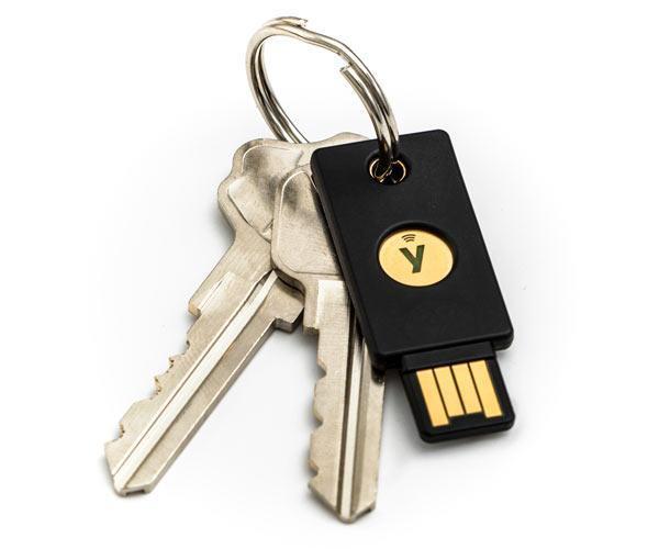Black YubiKey 5 NFC security key hanging on a keyring with keys, gold button with Y logo and USB-A plug